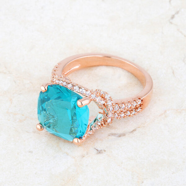 Rose goldtone plated ring photographed at an angle to show the full setting and stone placement
