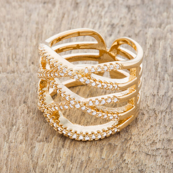 Goldtone wide band ring photographed on its own against a plain background
