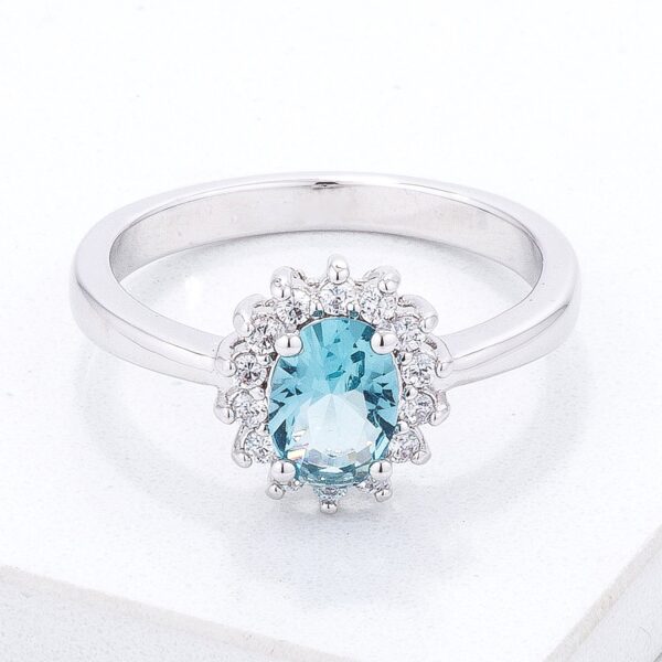 Silvertone ring with a blue oval cubic zirconia stone held by prong settings