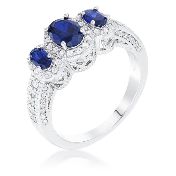 Rhodium plated ring with three oval-cut blue cubic zirconia stones in a halo setting