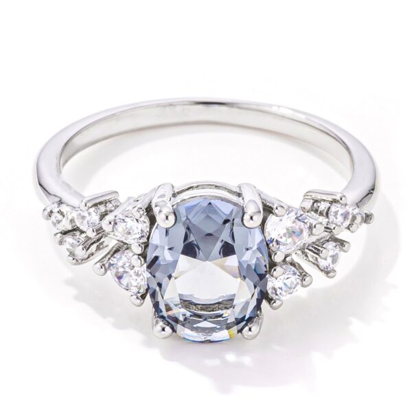 Grey oval cubic zirconia ring in a rhodium-plated setting, shown from the front