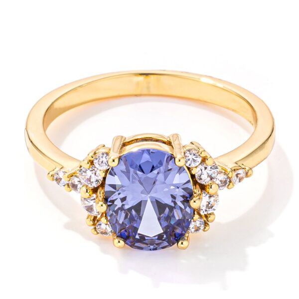 Gold plated ring with an oval tanzanite and cubic zirconia on a goldtone band