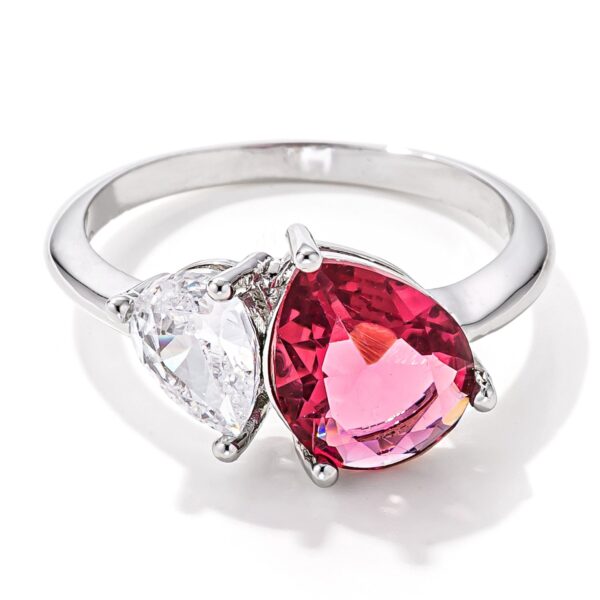 Ring with two pear-cut stones, one clear and one rose pink, set side by side on a rhodium plated band