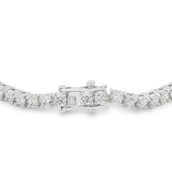 Close-up of cubic zirconia stones set in prongs on the tennis bracelet, showing facets and metalwork