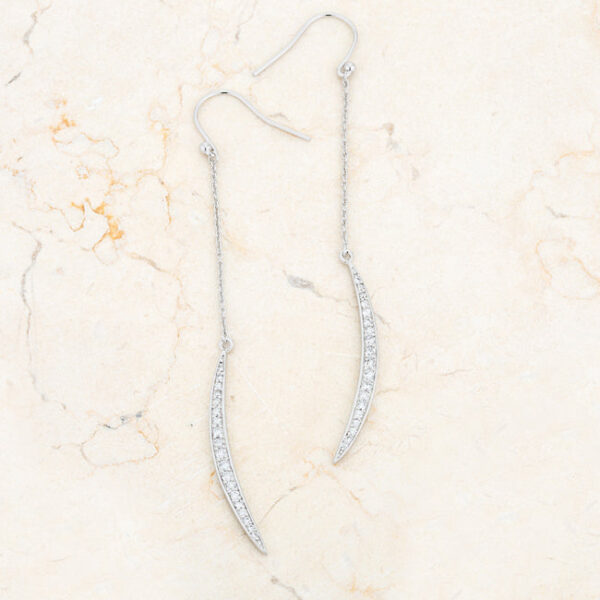 Moon drop earring shown at an angle to show the rhodium plated metal finish