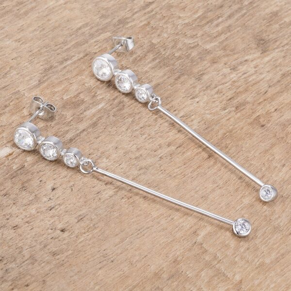 Angled view of the drop earrings showing the rhodium plated finish catching light across the stones