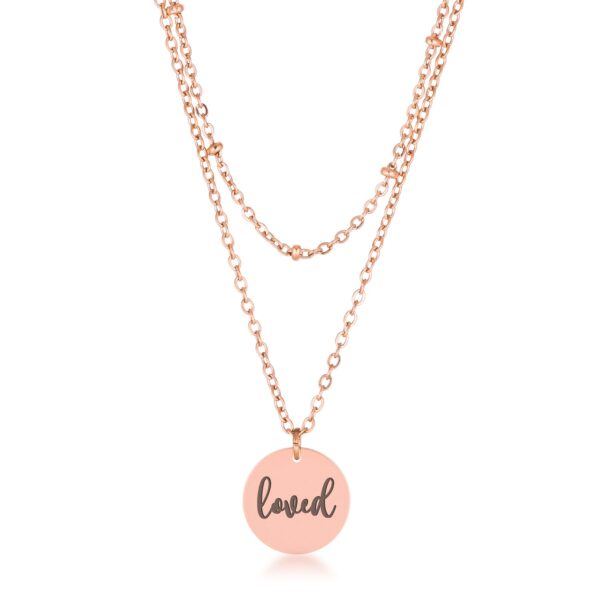 Layered chain necklace with a round rose tone pendant engraved loved
