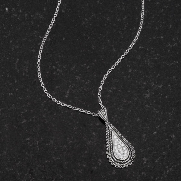Teardrop pendant necklace laid flat, showing the chain and pendant placement