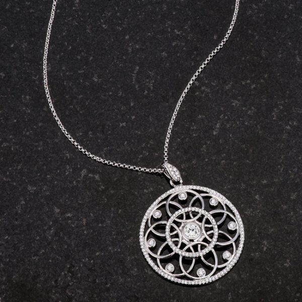 Rhodium plated pendant necklace displayed at an angle to show its dimension and finish
