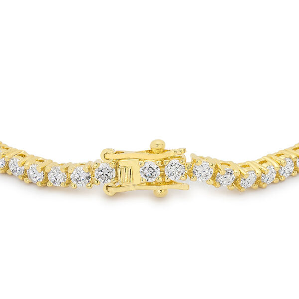 Close-up of prong-set cubic zirconia stones on the goldtone tennis bracelet