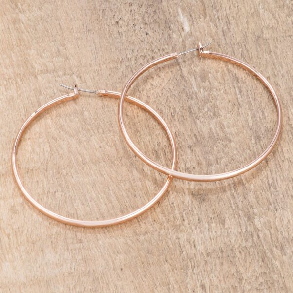 Close-up angle of a single rose gold plated hoop earring showing the metal surface