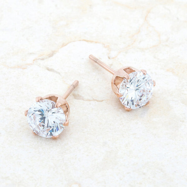 Rose goldtone stud earring photographed to show the stone's round cut and surface shine