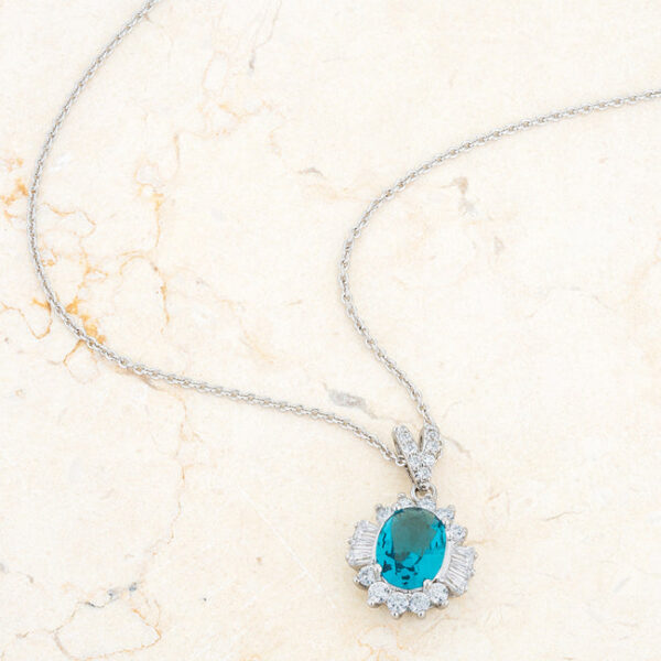 Aqua cubic zirconia drop necklace viewed at an angle to show the pendant's profile