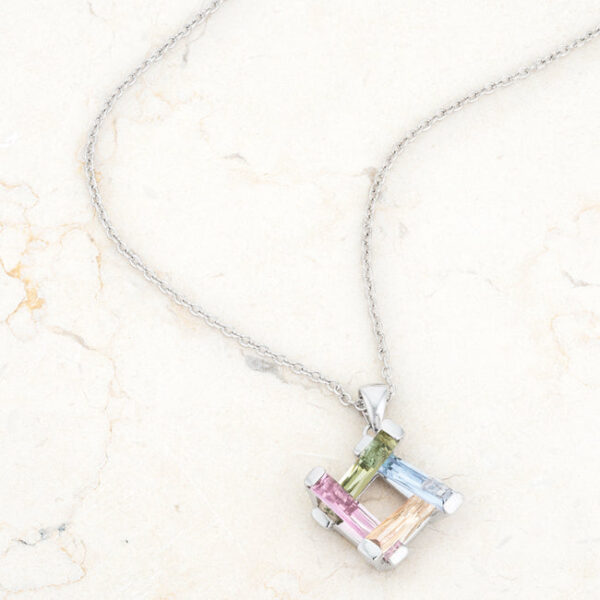 Pendant necklace angled to catch light across the rhodium plated metal and stone