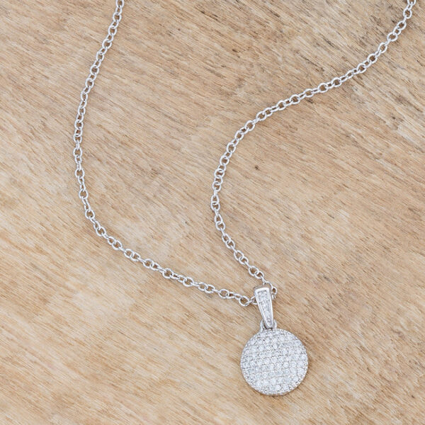Full length view of the rhodium necklace with cubic zirconia disk pendant laid flat