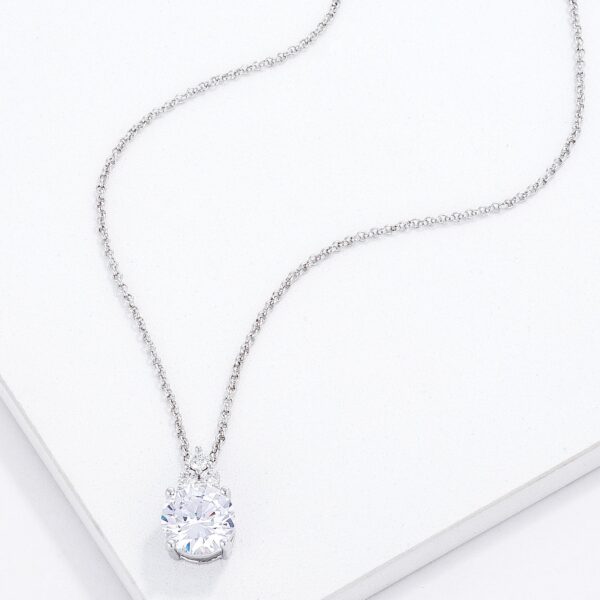 Close angle of the rhodium plated pendant showing the clear CZ stones and plated metal surface