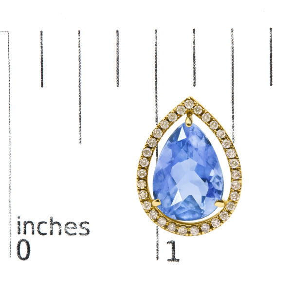 Earring shown next to a scale reference indicating its 9 x 13 mm stone size