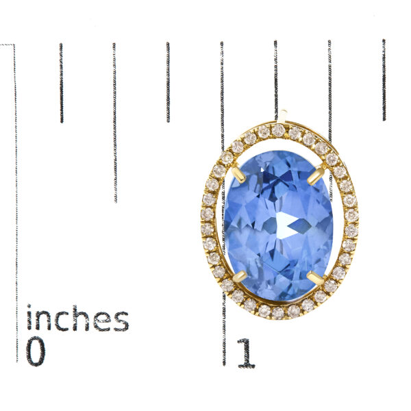 Blue fluorite stud earrings shown next to a scale reference for size