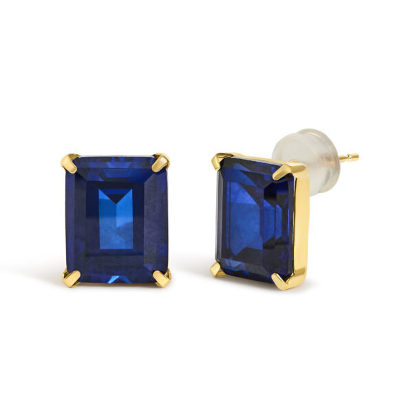Side angle of 18K yellow gold stud earrings showing the prong setting and gold basket