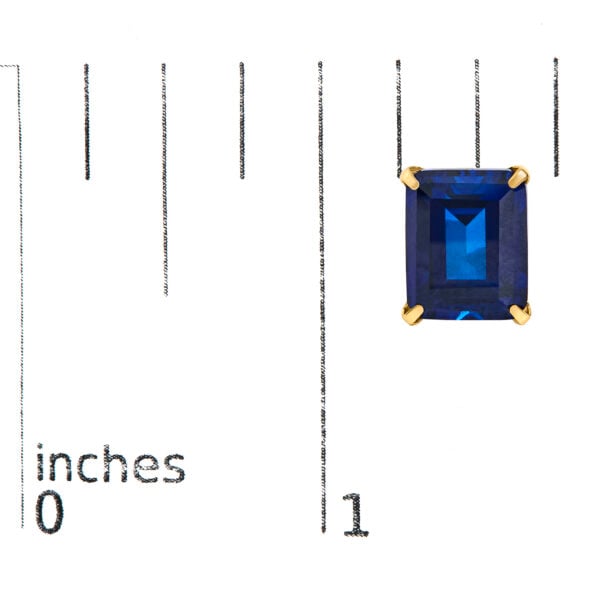 Stud earrings shown next to a scale reference indicating the 8 x 10mm stone size