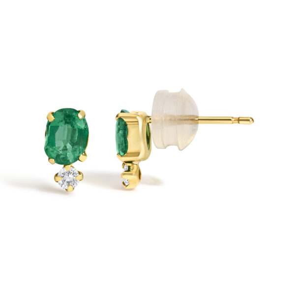 Close-up of the emerald and diamond earrings highlighting stone color and setting detail