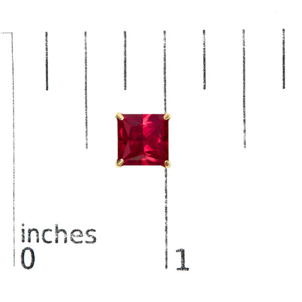 Ruby stud earrings shown next to a scale reference indicating their 7 x 7 mm stone size