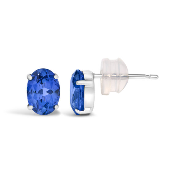Close-up of an oval blue sapphire stud earring highlighting the stone's color and cut