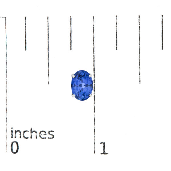 Platinum sapphire stud earrings shown next to a scale reference for size comparison