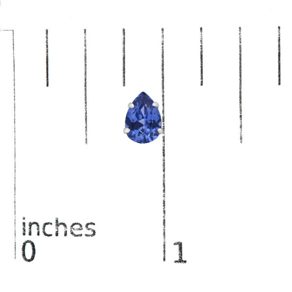 Platinum pear sapphire stud earrings shown next to a scale reference for size