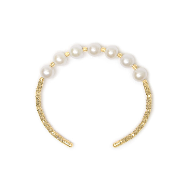 Close-up of the freshwater cultured pearls on the gold bangle, showing luster and surface texture
