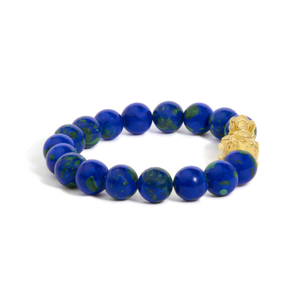 Close view of the yellow gold dragon charm among the blue azurite beads