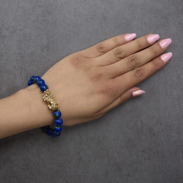 Bracelet worn on a wrist showing the azurite beads and dragon charm in place
