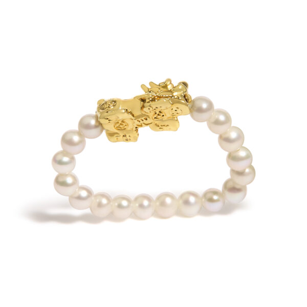 Ring photographed at an angle showing both the dragon charm and pearl band together