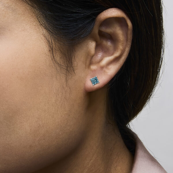 Stud earrings shown worn on an ear to illustrate placement and fit