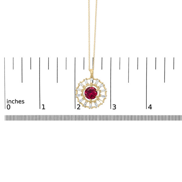 Pendant photographed next to a scale reference showing its size in inches