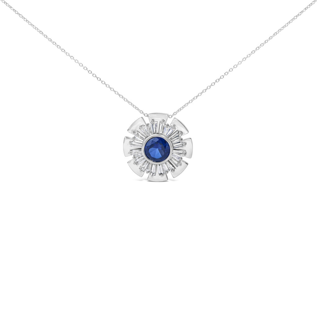 Sunburst pendant necklace with a bezel-set blue sapphire center and baguette diamond rays on a cable chain