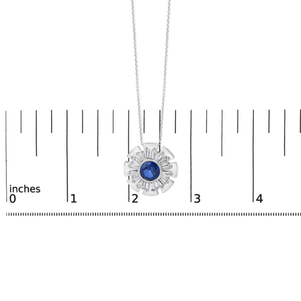 Sunburst pendant necklace shown next to a scale reference for size comparison