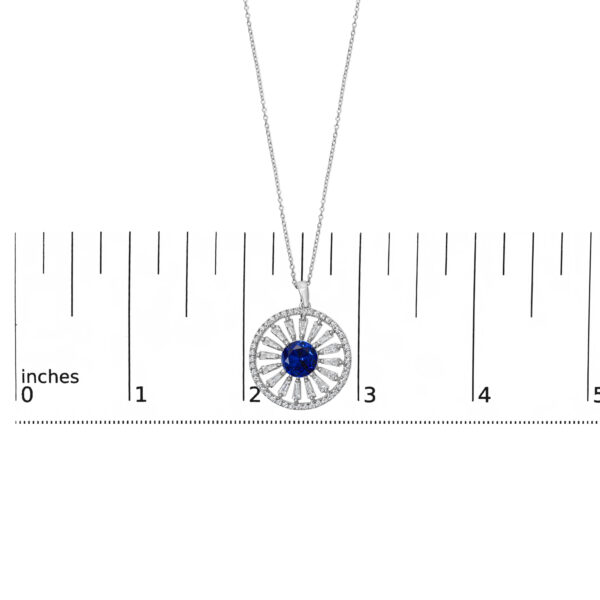 Pendant shown next to a scale reference indicating its size in inches