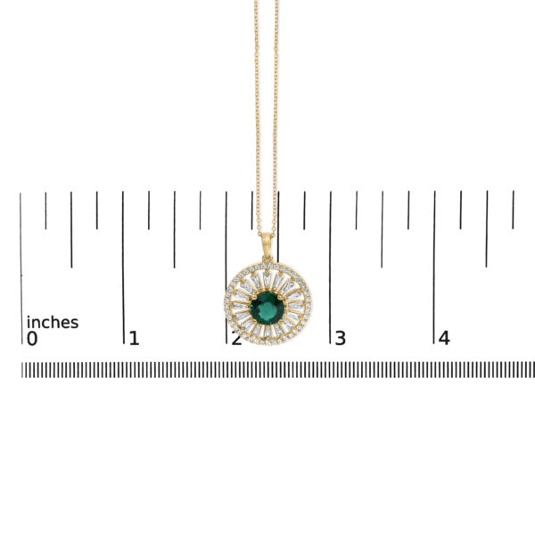 Pendant shown next to a ruler for scale reference