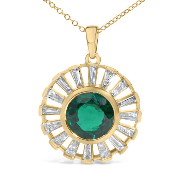 Close-up of the pendant showing the bezel-set emerald and channel-set baguette diamonds
