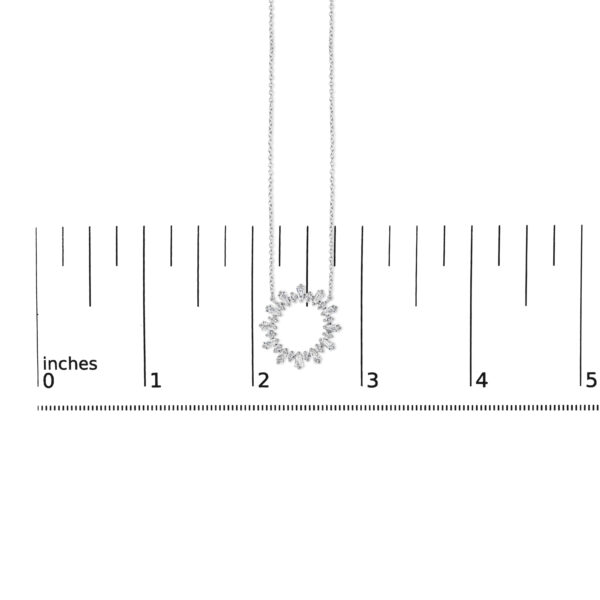 Diamond starburst medallion pendant shown next to a scale reference for size