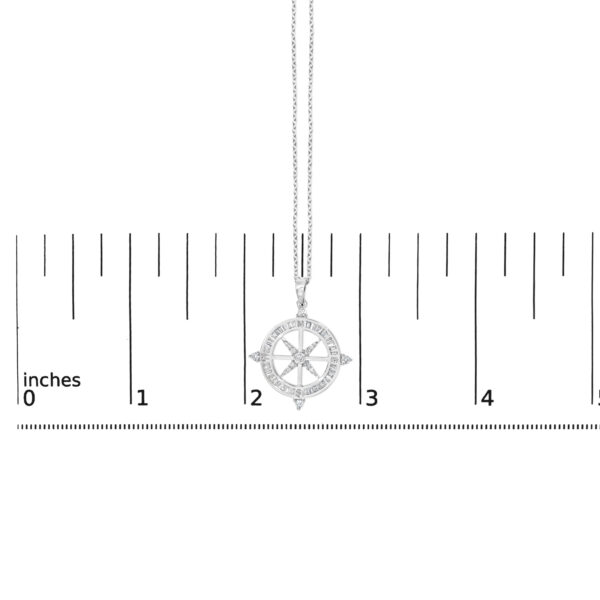 Compass medallion pendant shown next to a ruler for size reference