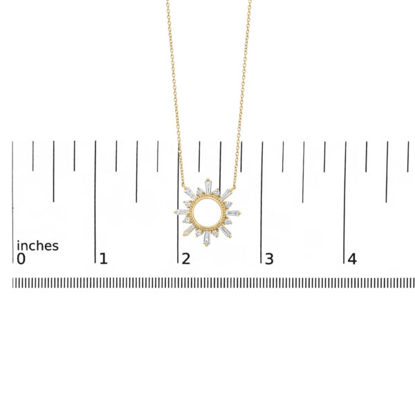 Starburst pendant necklace shown next to a scale reference for size