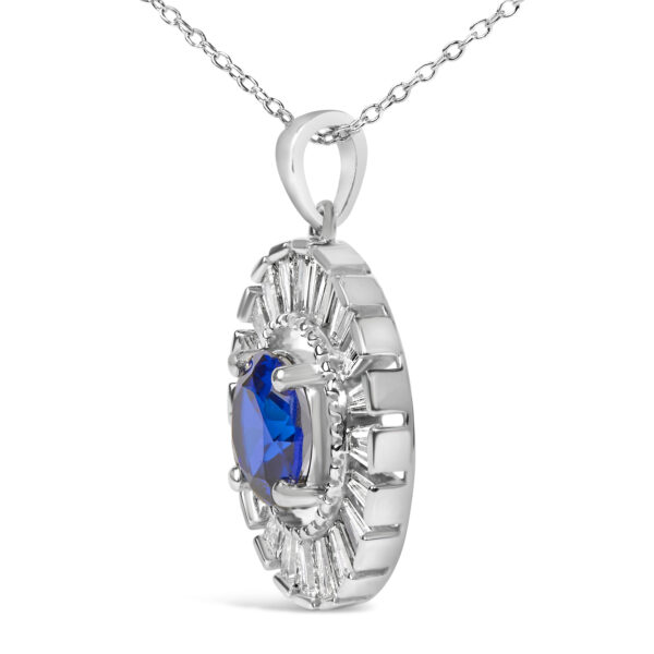 Side view of the pendant showing the prong setting holding the round blue stone above the diamond halo