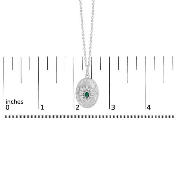 Pendant photographed next to a scale reference to show its size
