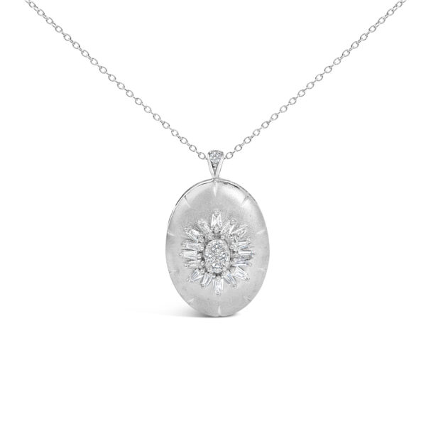 Puffed oval medallion pendant in white metal set with baguette and round diamonds, on a cable chain