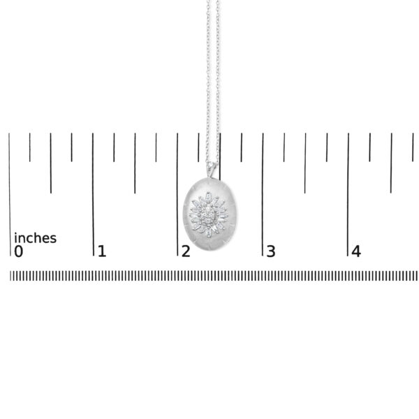 Pendant and chain shown next to a ruler for scale reference