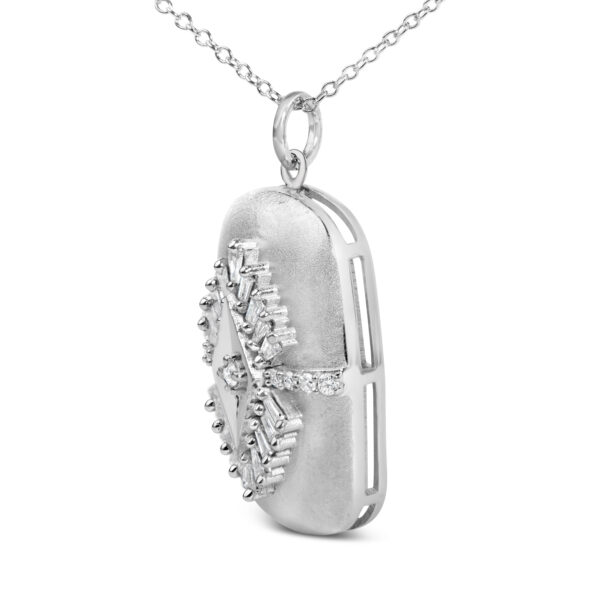 Close-up of the prong-set baguette and round diamonds on the medallion pendant