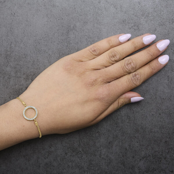 24K gold plated diamond circle bolo bracelet worn on a wrist