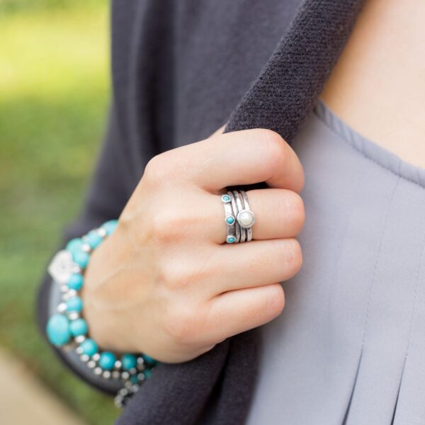 Alternate angle of the oxidized split band ring showing the center stone and colored stones
